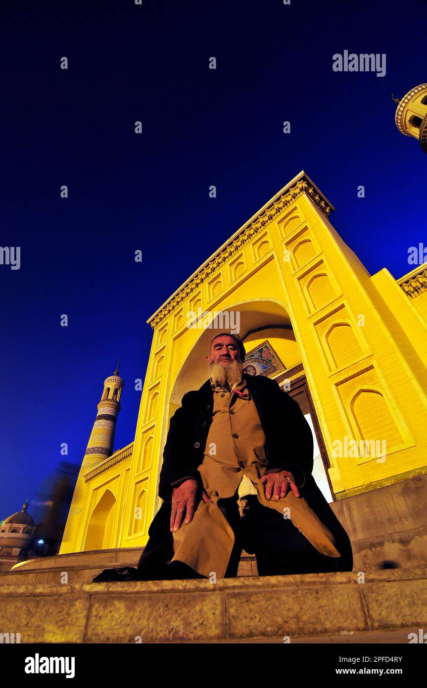 Ein uigurischer Mann betet vor der ID Kah Moschee in Kashgar, Xinjiang, China. Stockfoto