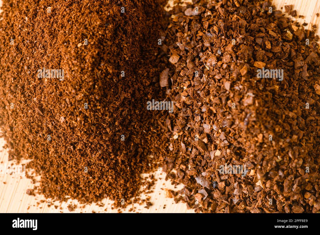 Nahaufnahme der Struktur von Mahlkaffeesorten für Kanne und Espresso auf Holztisch, natürlicher neutraler Hintergrund Stockfoto