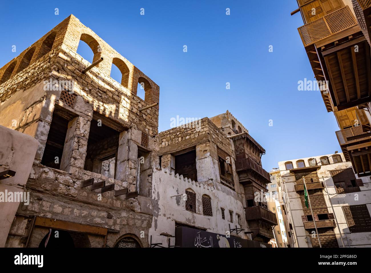 Außenansicht eines verfallenen traditionellen Wohnhauses neben einem kürzlich renovierten Gebäude, Al-Balad, Jeddah, KSA, Saudi-Arabien Stockfoto