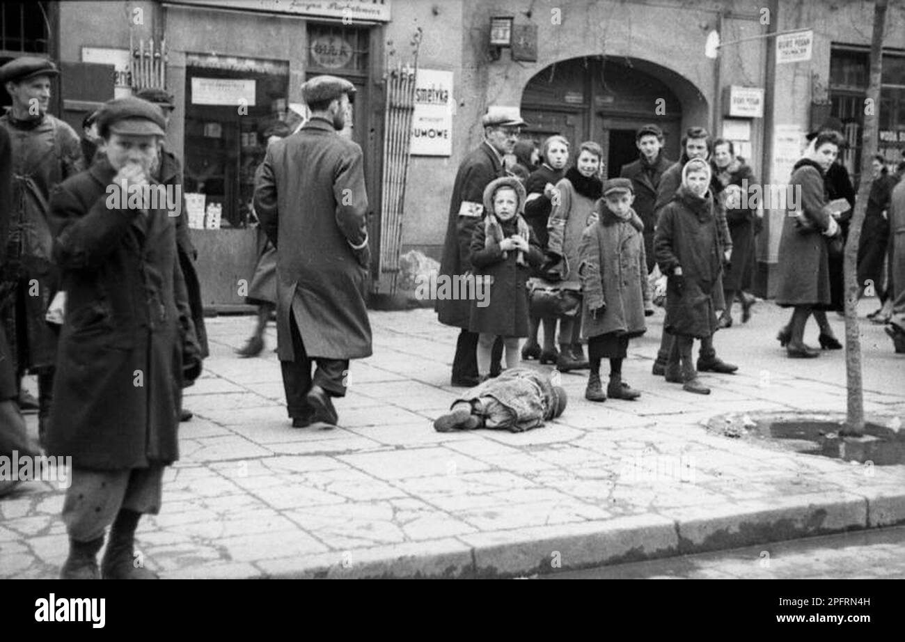 In den frühen Stadien des Jahres WW2 wurden die Juden in den von den nazis besetzten europa zusammengeführt und in überfüllte Ghettos gezwungen. Als die Entscheidung getroffen wurde, sie alle zu töten, wurden sie in Vernichtungszentren deportiert, um sie zu töten. Dieses Bild zeigt die Leiche eines toten oder sterbenden Kindes, das WW2 auf den Straßen des Warschauer Ghettos lag. Bild 101I-134-0771A-39/Zermin/CC-BY-SA 3,0 Stockfoto