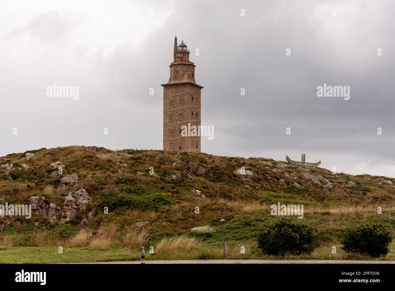 Der Torre de Herkules, ein antiker römischer Leuchtturm und Symbol von La Coruña, Galicien, Spanien, steht hoch vor dem blauen Himmel und bietet einen Blick auf die Stadt Stockfoto