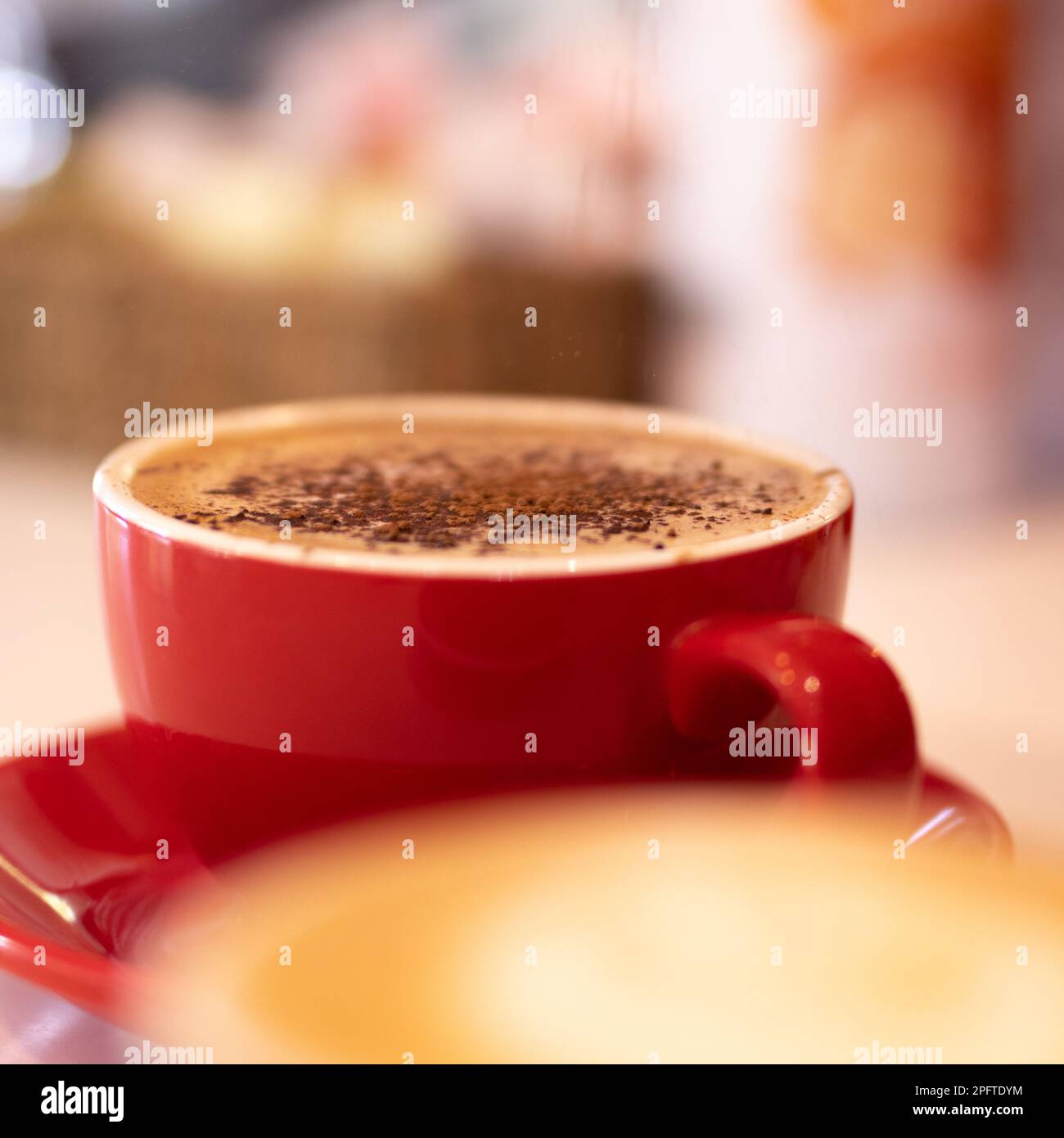 Cappuccino mit Schokolade im roten Becher Stockfoto