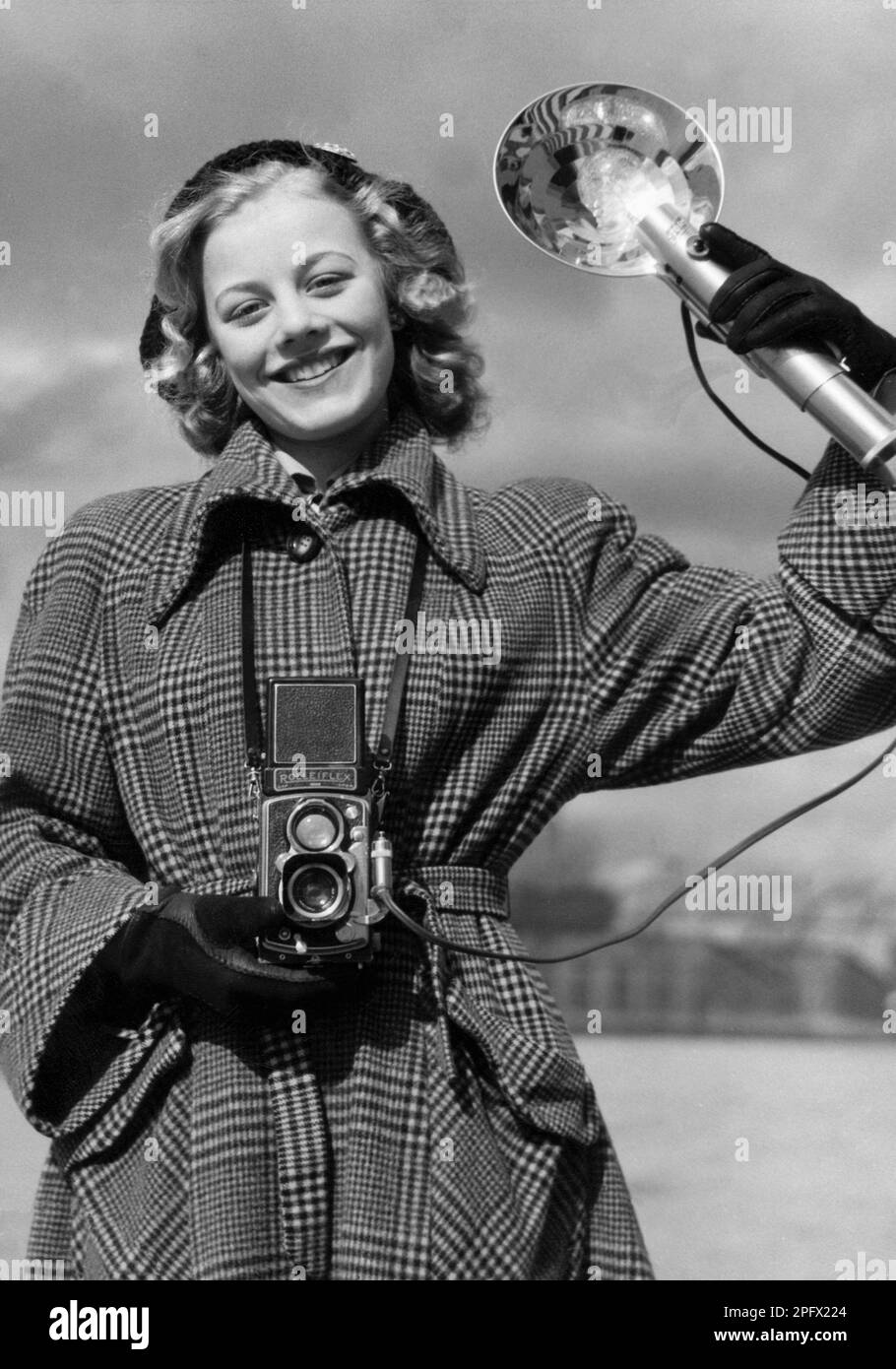 Amateurfotograf in den 1950er. Die junge Schauspielerin Sangrid Nerf fotografiert an einem Frühlingstag. Bei der Kamera handelt es sich um eine Rolleiflex-Kamera des deutschen Unternehmens Rollei für 60-mm-Filme. Schweden 1950. Stockfoto