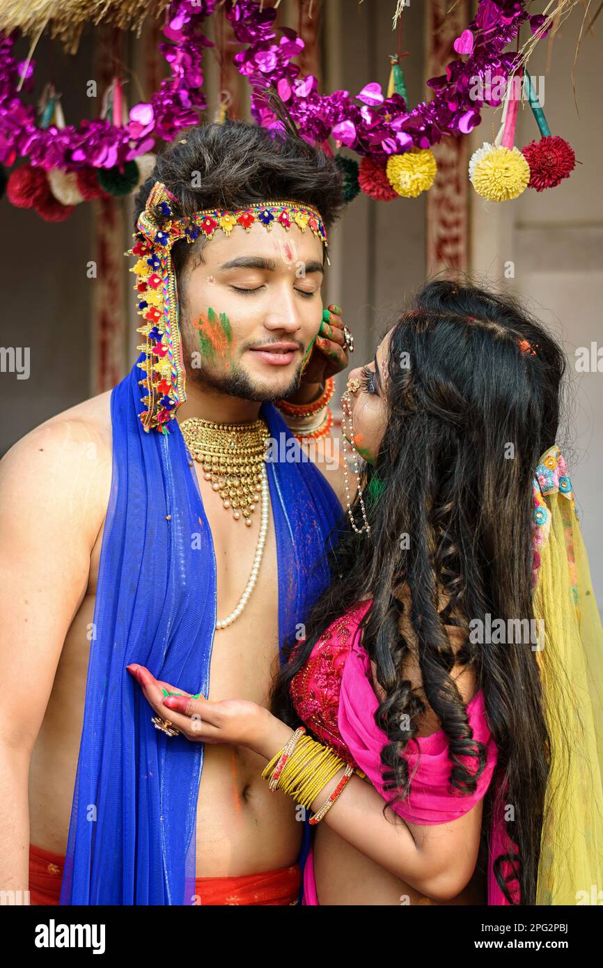Junge Künstler verkleidet als Lord Krishna und Göttin Radhaand, die auf dem Festival der Farben namens Holi, einem beliebten hinduistischen Festival, mit Farben spielt Stockfoto