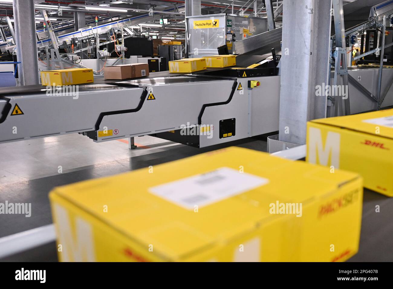 Deutsche Post DHL nimmt am 20. März 2023 den größten Paketstandort Deutschlands in Betrieb. Bearbeitung von bis zu 72.000 Paketen pro Stunde im Aschheim II-Paketzentrum bei München. Paket, Pakete auf Bändern, Förderband, Förderbänder? Stockfoto