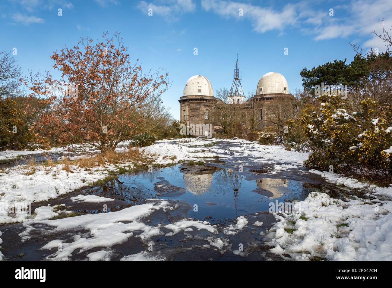 Birkenhead, Großbritannien - März 10 2023: Bidston Observatory reflektiert in einem Pool an einem verschneiten Morgen, Wirral-Halbinsel. Erbaut 1866 von George Fosbery Lyster. Stockfoto