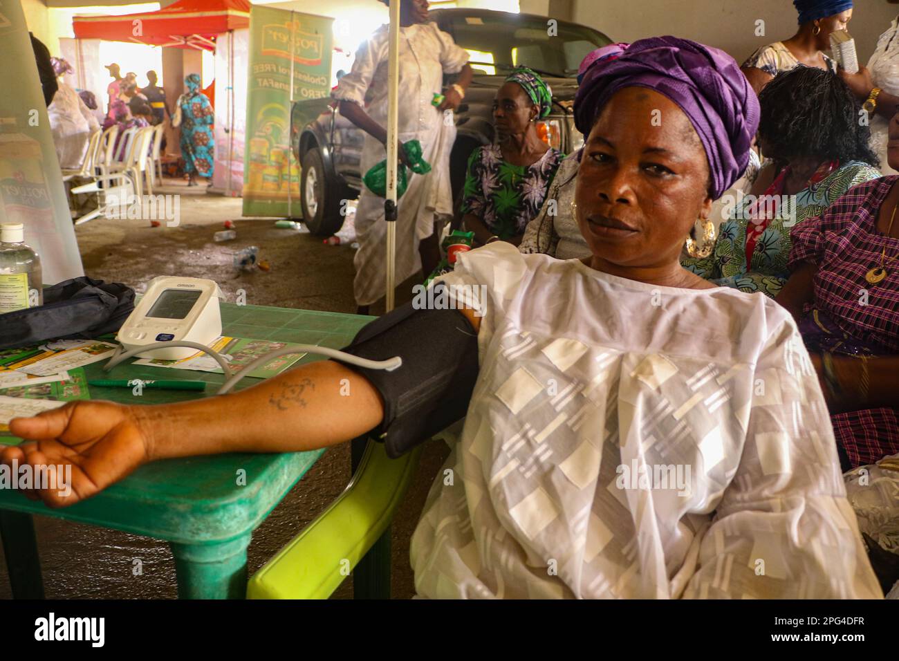 Medizinisches Personal betreut die Frau während einer kostenlosen medizinischen Untersuchung anlässlich des Internationalen Frauentags in der Mobolaji Johnson Arena in Lagos, Nigeria. Stockfoto