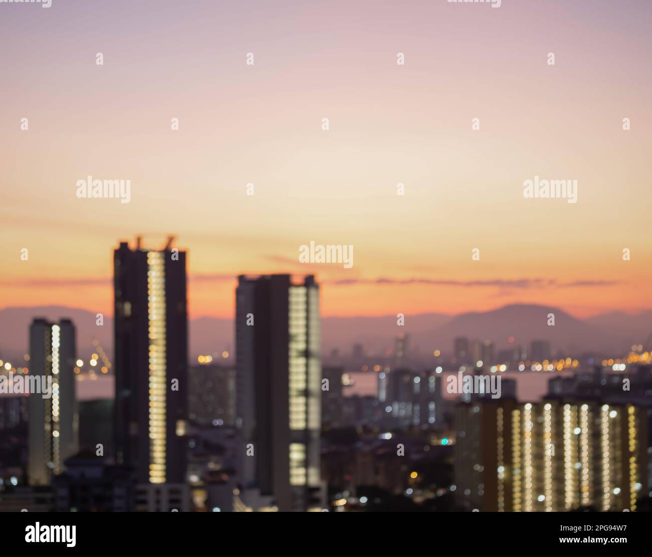 Verschwommenes Firmengebäude eines Stadthotels mit blauem morgendlichen Geschäftsergebnis. Skyline-Licht vor dem Bürofenster mit grauer Sicht auf den Himmel. Tag-Bokeh Stockfoto