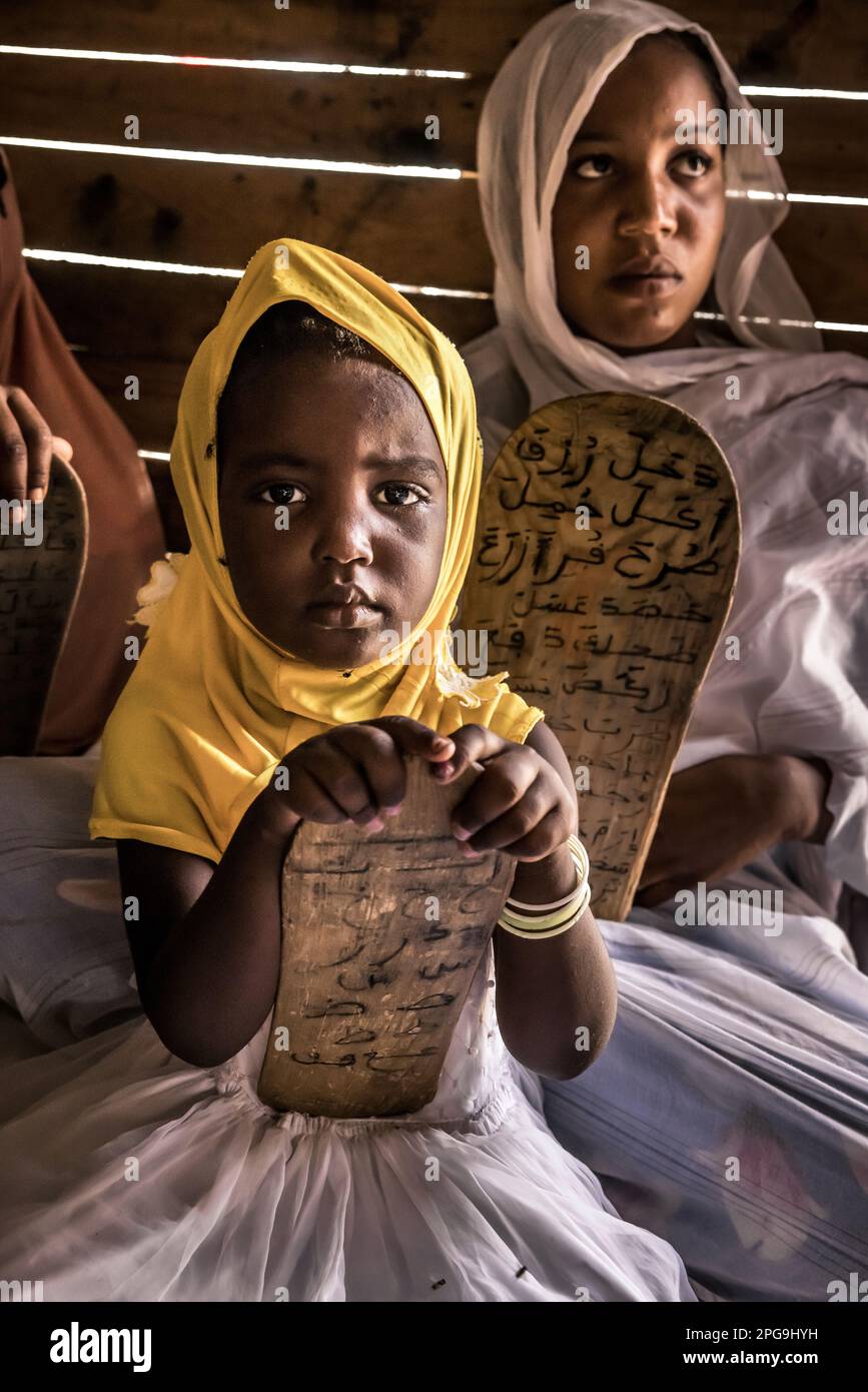 Die Kinder der Koranschule im Bezirk Darbedda gehören hauptsächlich dem benachteiligten Stamm der Haratin an und können dank der Hilfe der NRO Sahel Fondation von Brahim Ramdhane in Nouakshott in Mauretanien an der Koranschule teilnehmen. Stockfoto