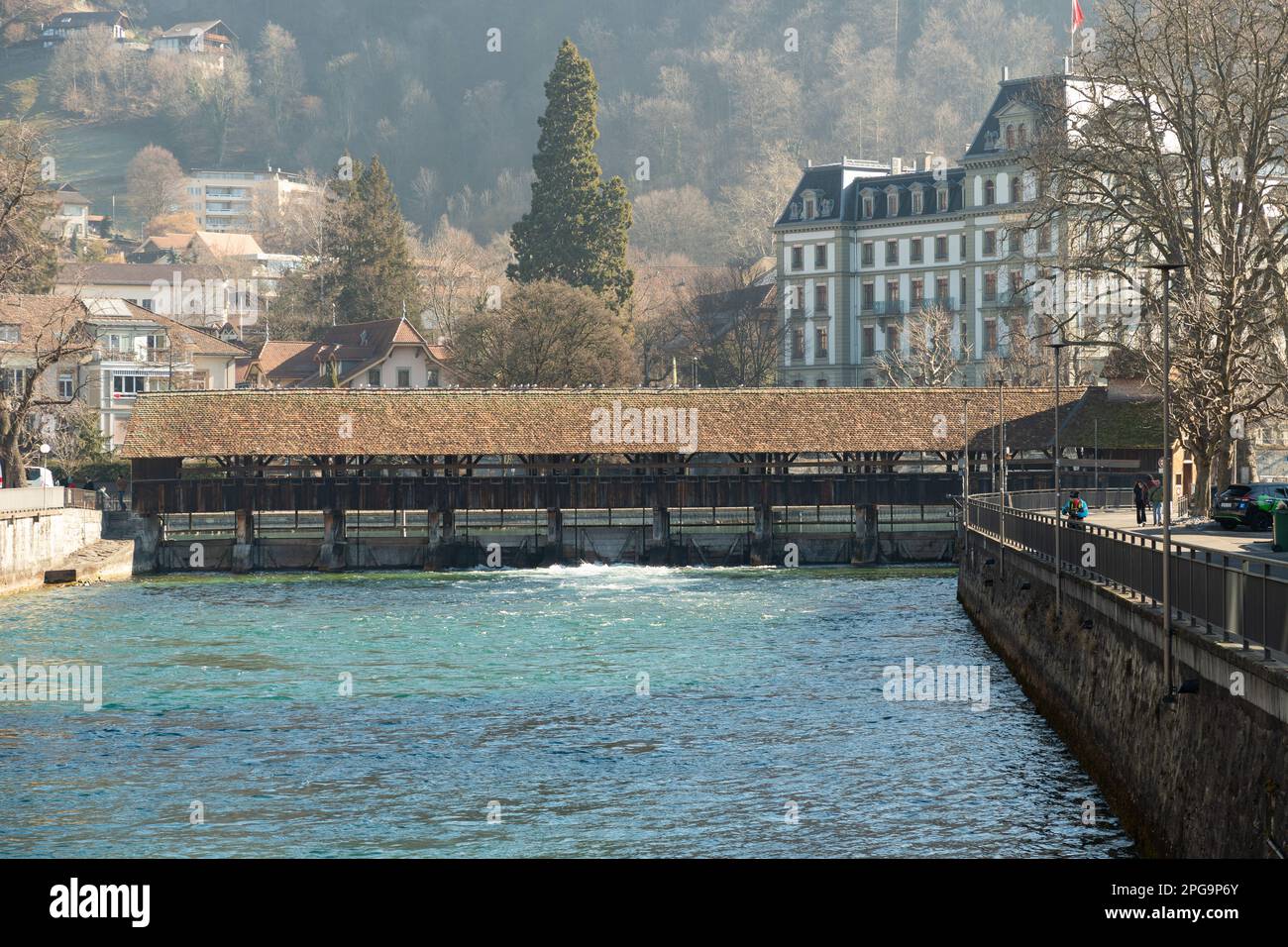 Thun, Schweiz, 13. Februar 2023 Historische alte Holzbrücke über den Fluss Aare an der Wasserpromenade im Stadtzentrum Stockfoto