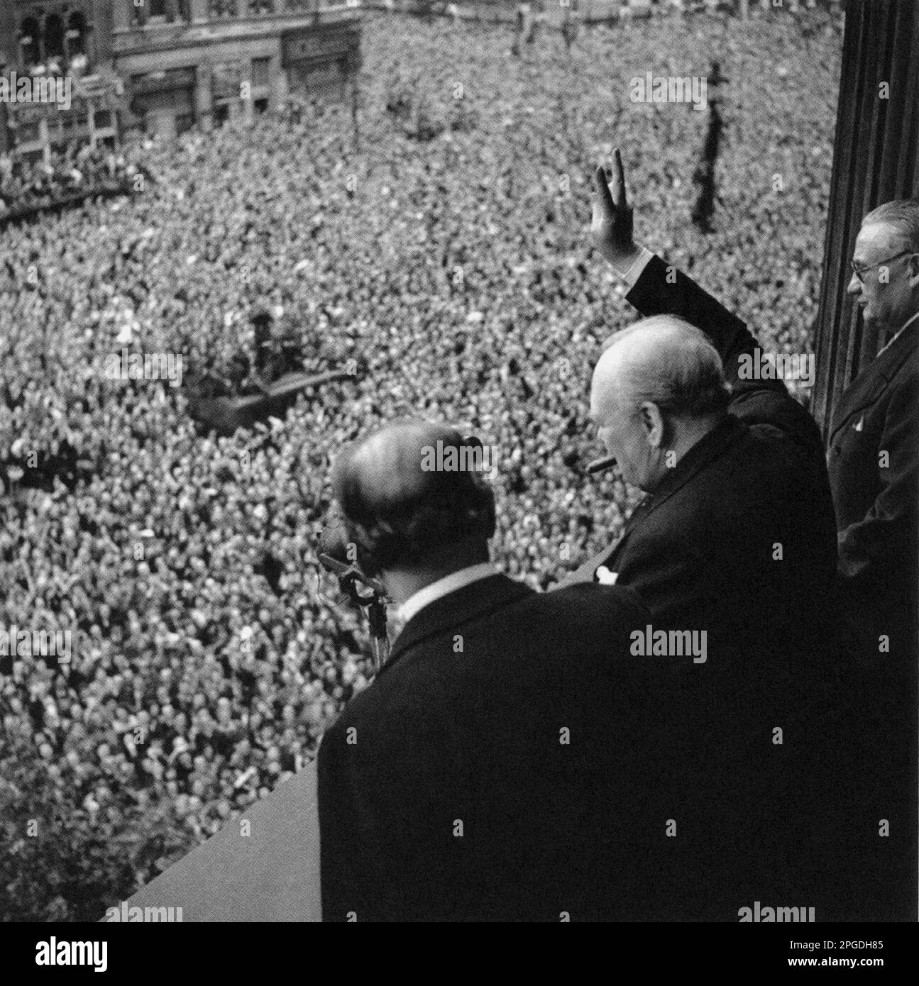 Winston Churchill winkt den Menschenmassen in Whitehall am VE Day zu. 8. Mai 1945 Stockfoto