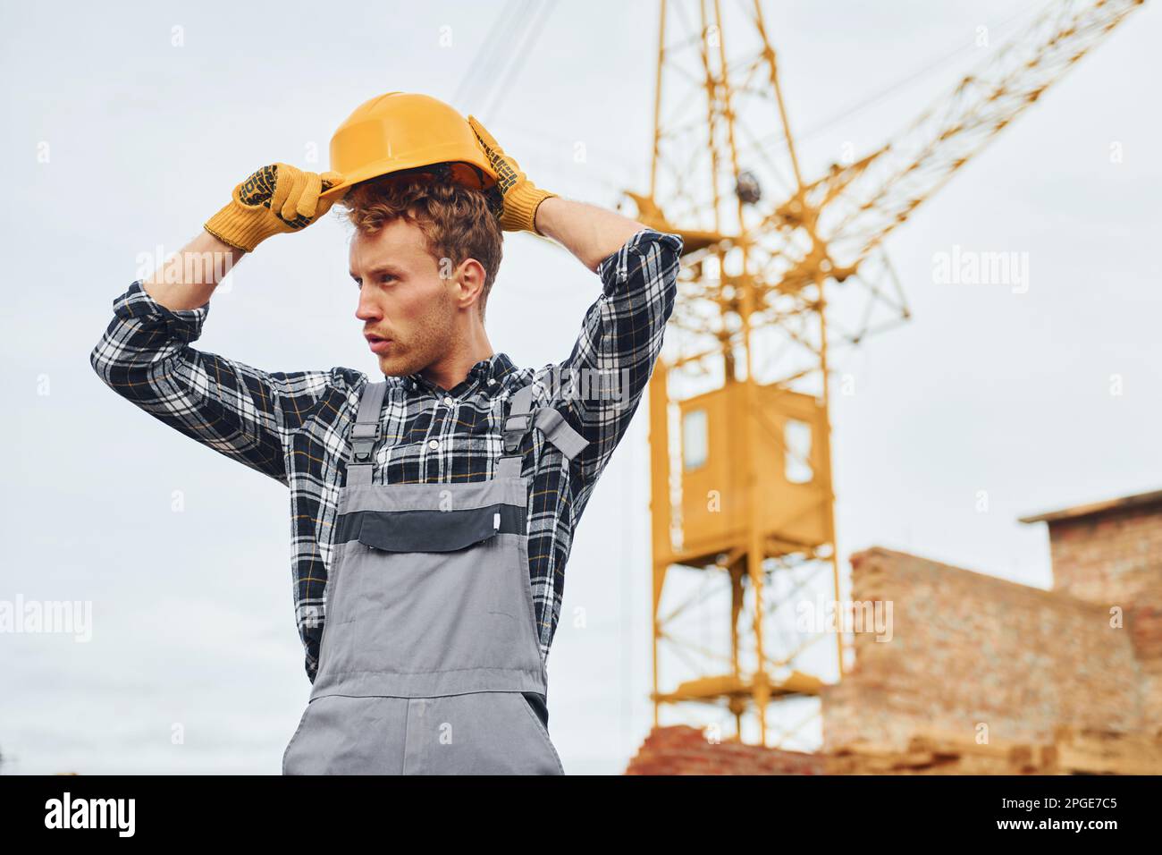 Macht eine Pause. Bauarbeiter in Uniform und Sicherheitsausrüstung arbeiten am Gebäude Stockfoto