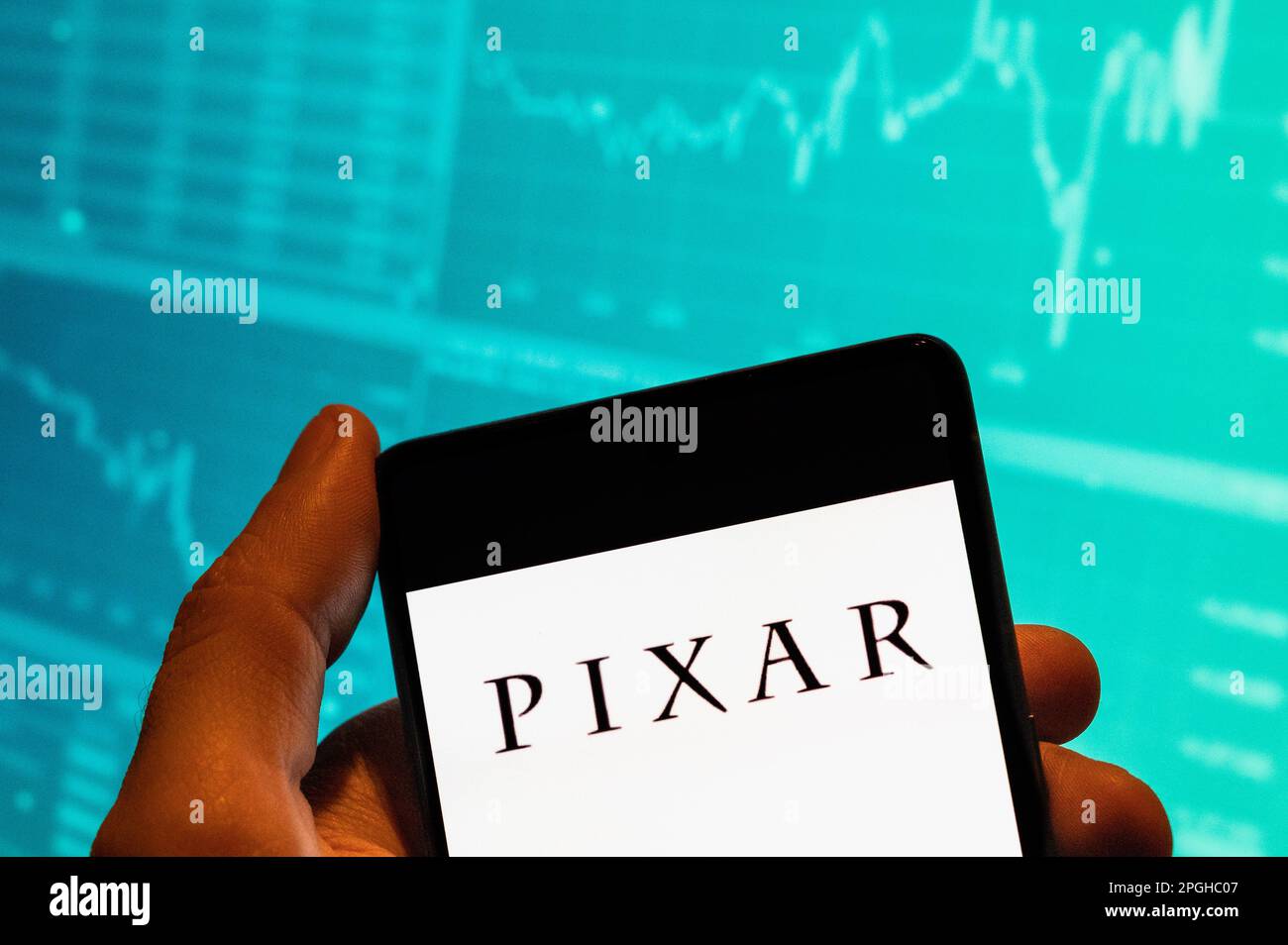 China. 15. Februar 2023. In dieser Fotoabbildung wird das Pixar-Logo des amerikanischen Computeranimationsstudios Disney auf einem Smartphone mit einer Grafik des Börsenindex im Hintergrund angezeigt. (Kreditbild: © Budrul Chukrut/SOPA Images via ZUMA Press Wire) NUR REDAKTIONELLE VERWENDUNG! Nicht für den kommerziellen GEBRAUCH! Stockfoto