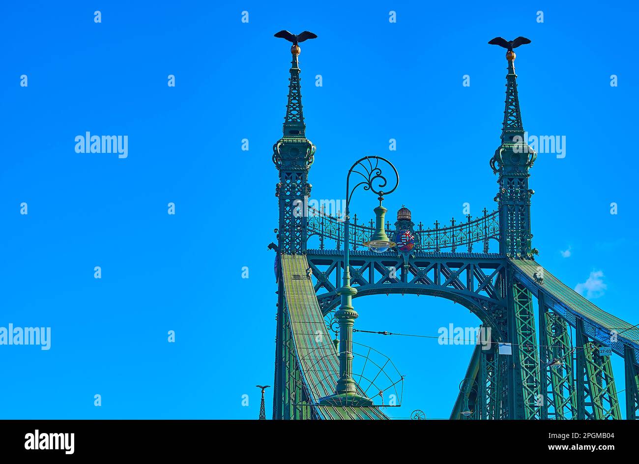 Die Skulpturen der Turuler Vögel auf den grünen Türmen der atemberaubenden Freiheitsbrücke im Jugendstil vor dem hellblauen Himmel, Budapest, Ungarn Stockfoto