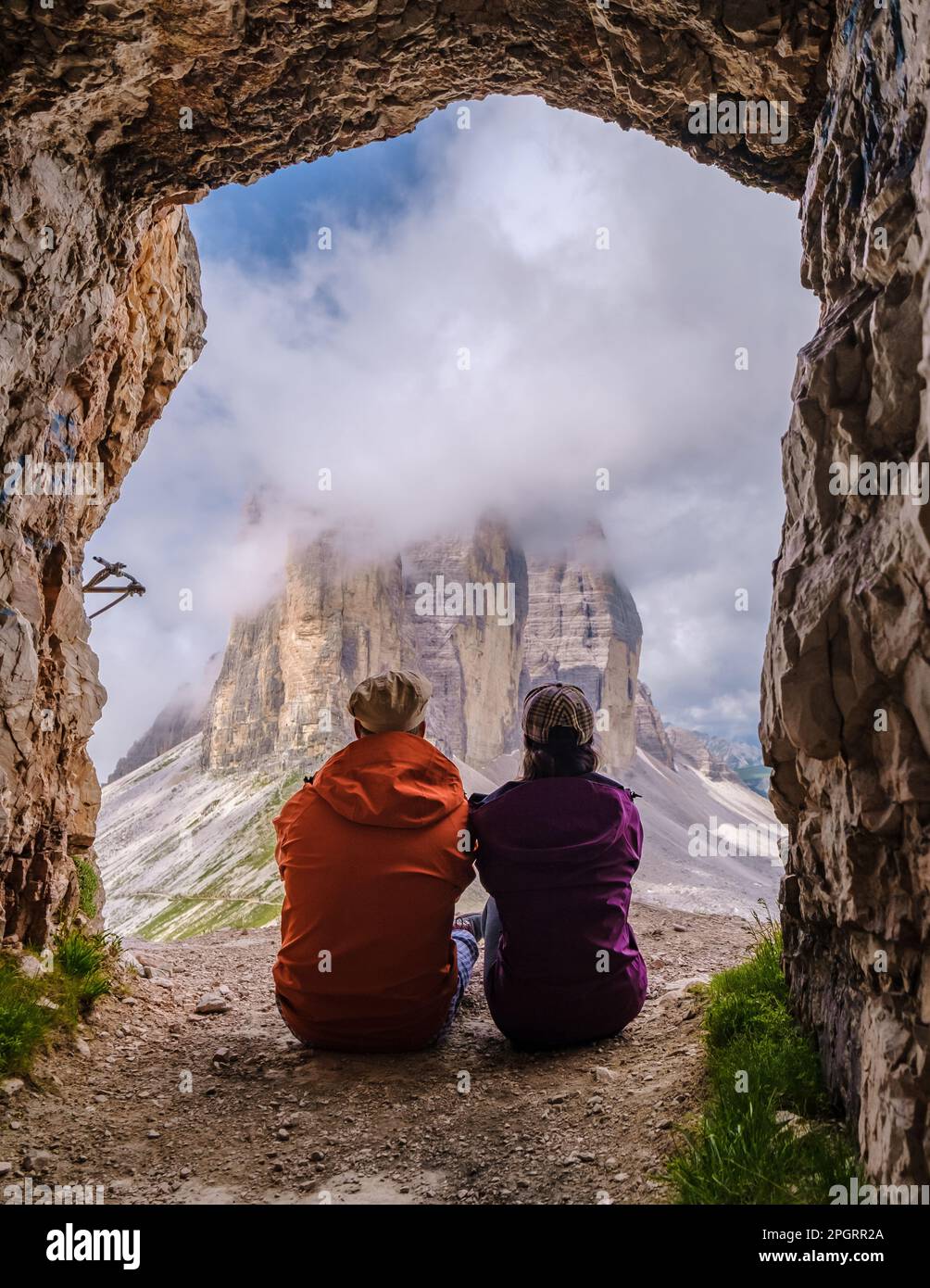 Tre Cime di Lavaredo Peaks oder drei Zinnen bei Sonnenuntergang, Dobbiaco Toblach, Trentino-Südtirol, Italien. Europäische Alpen. Ein paar Männer und Frauen, die in den Dolomiten wandern Stockfoto