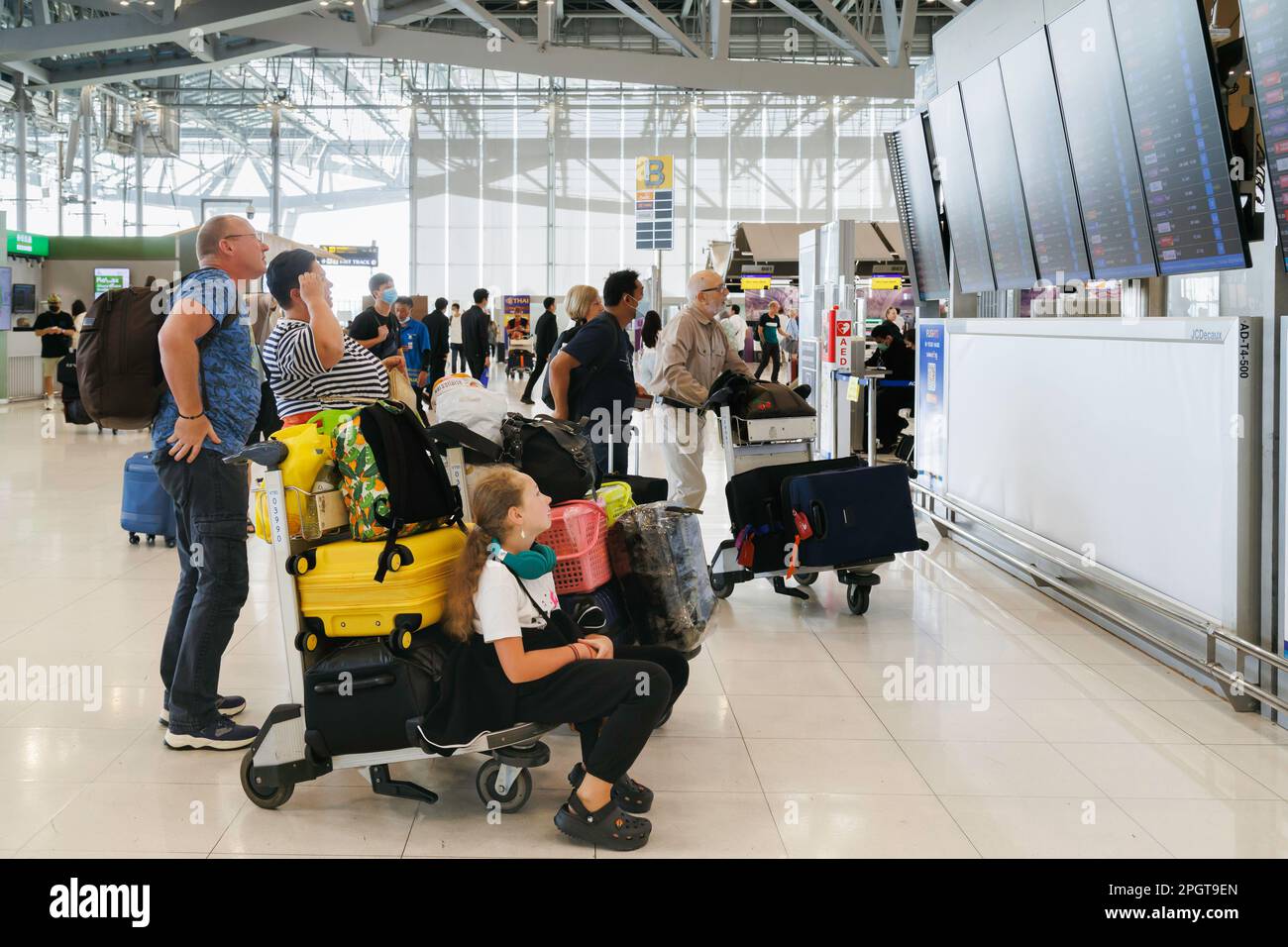Bangkok, Thailand - 16. Februar 2023 : Familientouristen überprüfen die Flugplantafel für Abflug und Ankunft am flughafen suvarnabhumi. Tailan Stockfoto