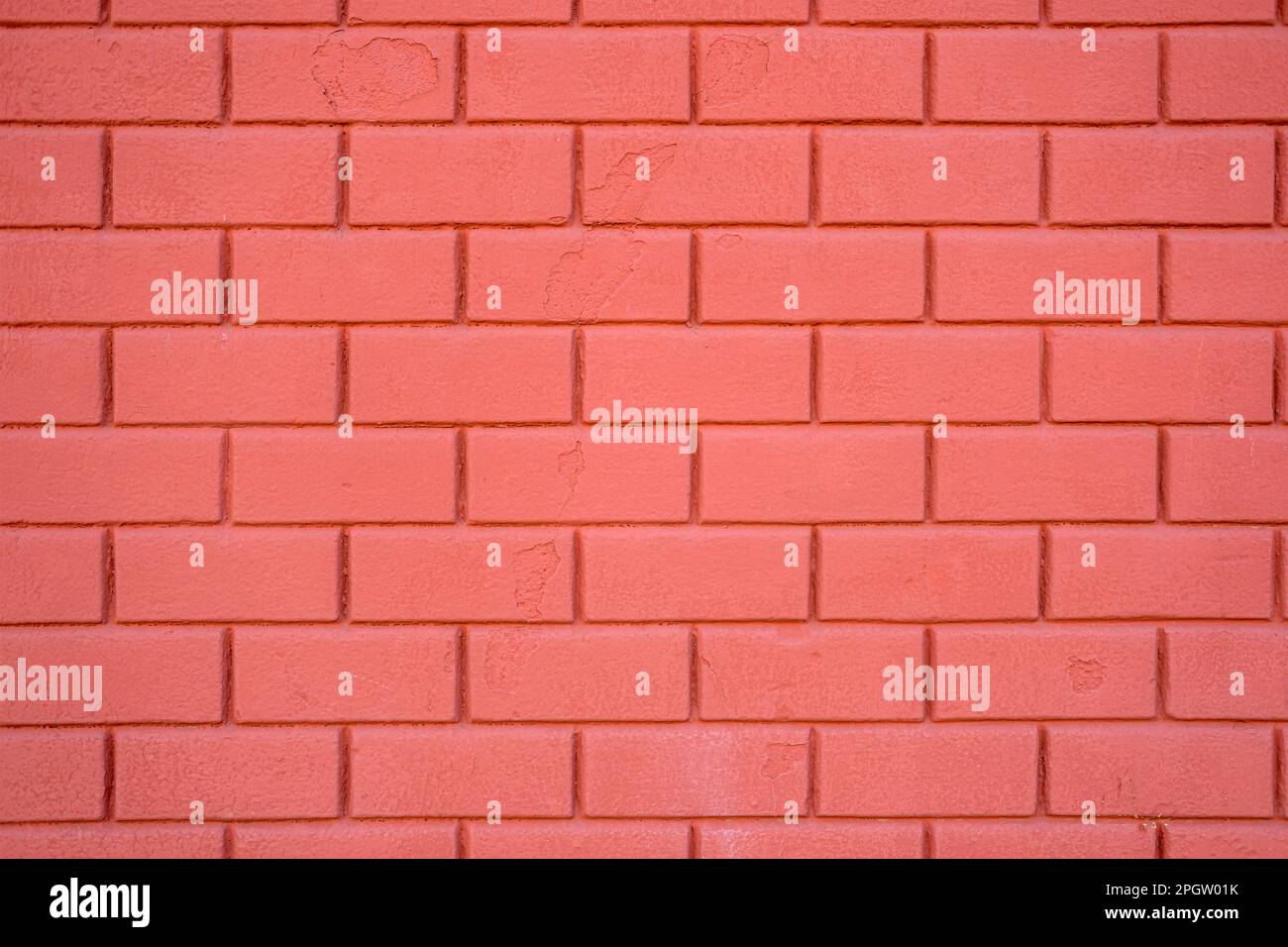 Hintergrund einer roten Steinmauer Stockfoto