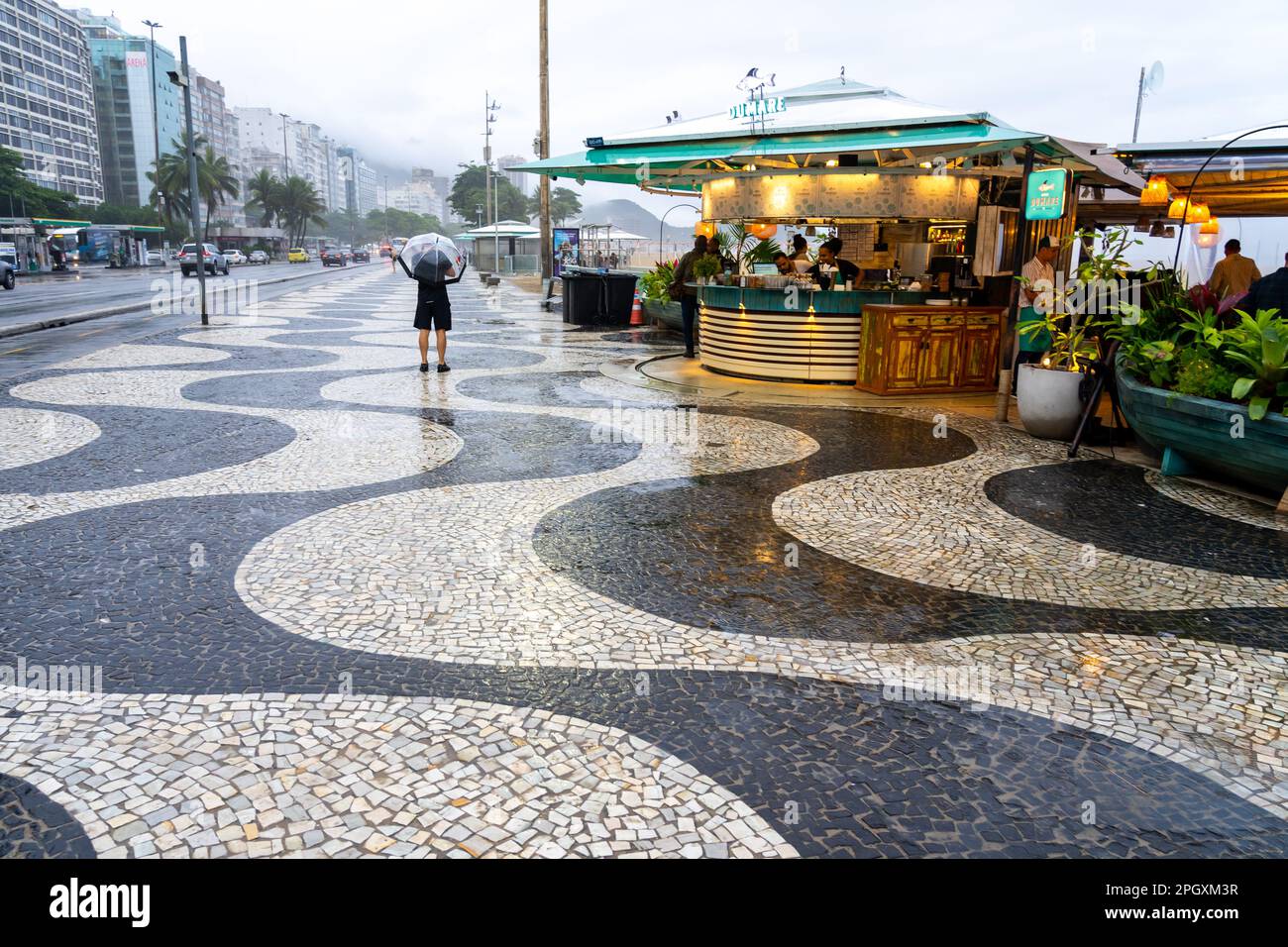 Der Blick auf den Bürgersteig mit den Restaurants an einem regnerischen Tag am Copacabana Beach, Rio de Janeiro, Brasilien. Stockfoto