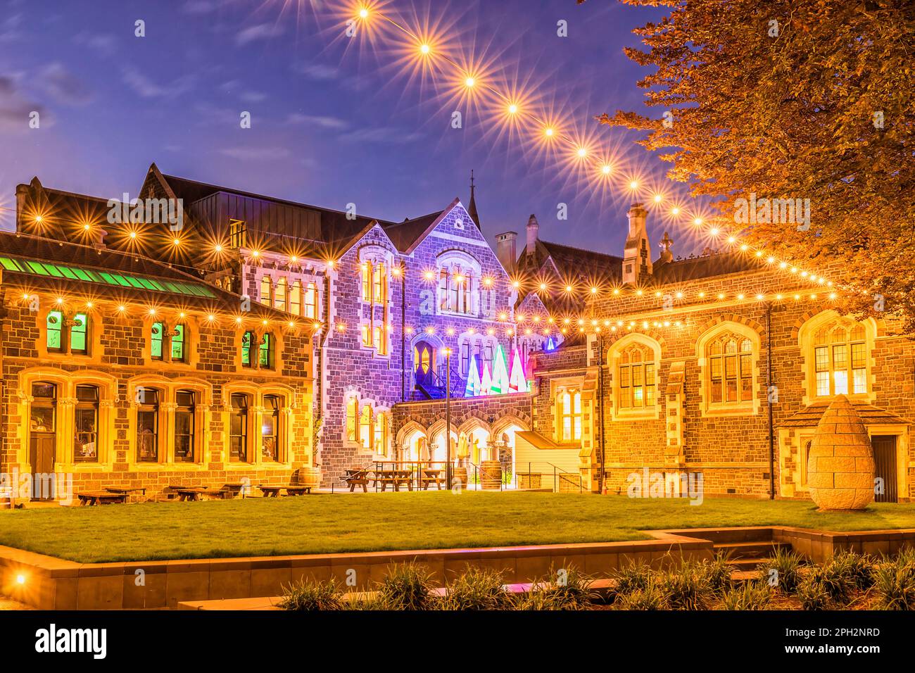 Historisches Architekturviertel des öffentlichen Parks in Christchurch, Neuseeland, bei Weihnachtslichtern, Zeit des Sonnenuntergangs. Stockfoto