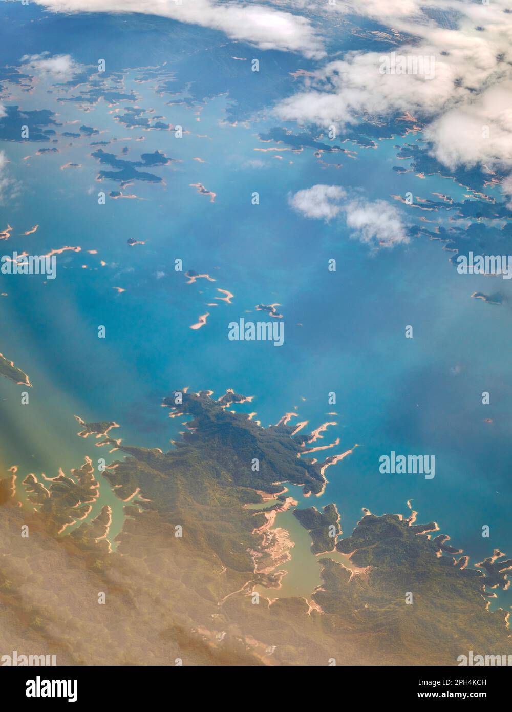 Ein Blick aus der Vogelperspektive auf eine riesige Fläche des blauen Ozeans mit grünem Land. China. Stockfoto