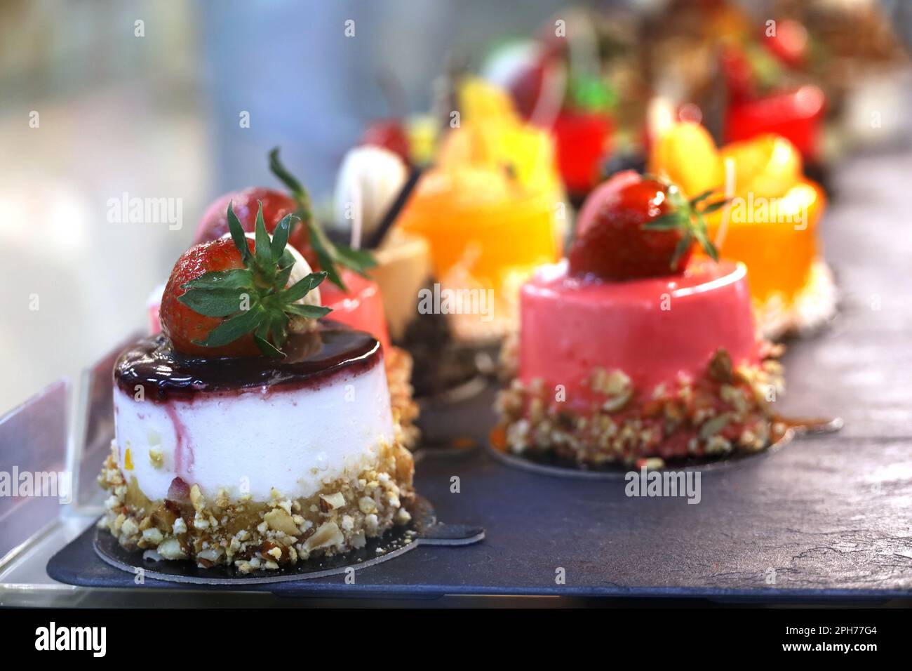 Kuchen mit frischen Beeren, selektiver Fokus. Süße Desserts mit Erdbeeren und Sahne im Café Showcase Stockfoto