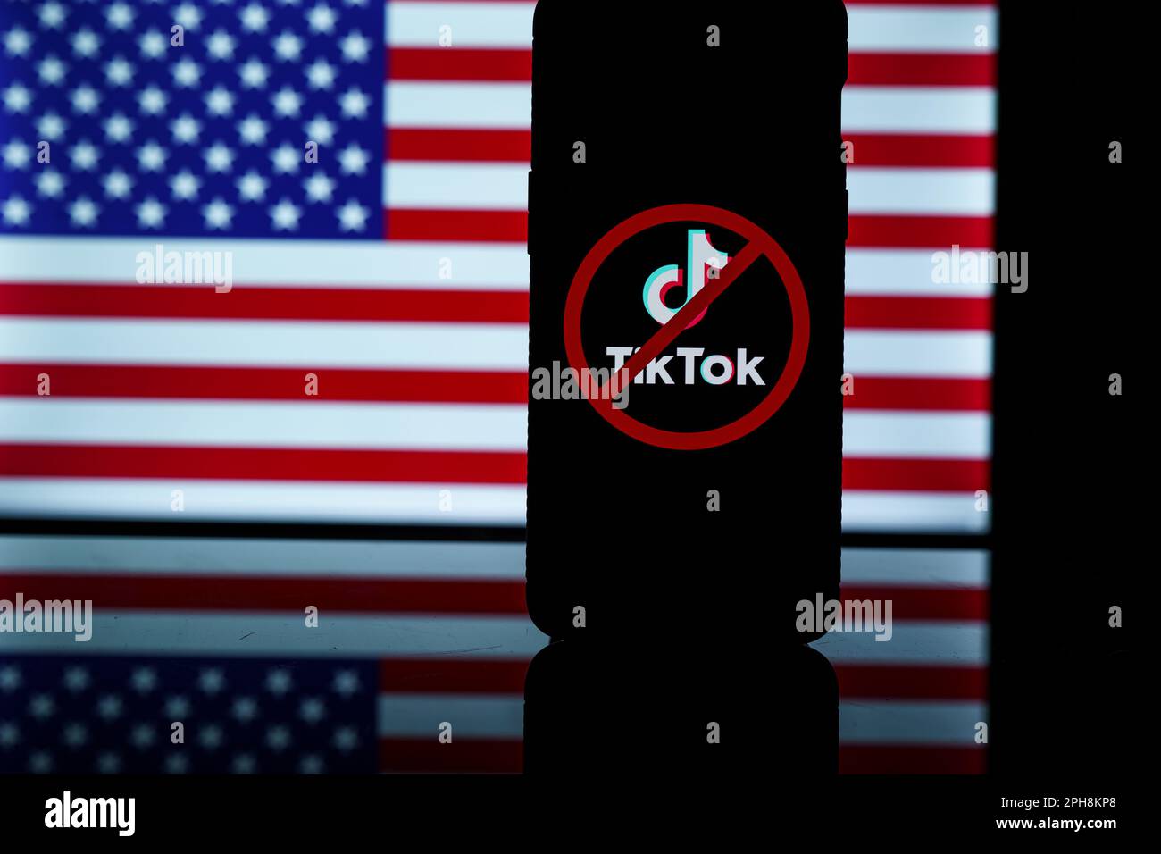 Kaunas, Litauen - 2023. März 25: TikTok-Logo mit Verbotssymbol im Hintergrund der US-Flagge. Sanktionen gegen Tik Tok Stockfoto
