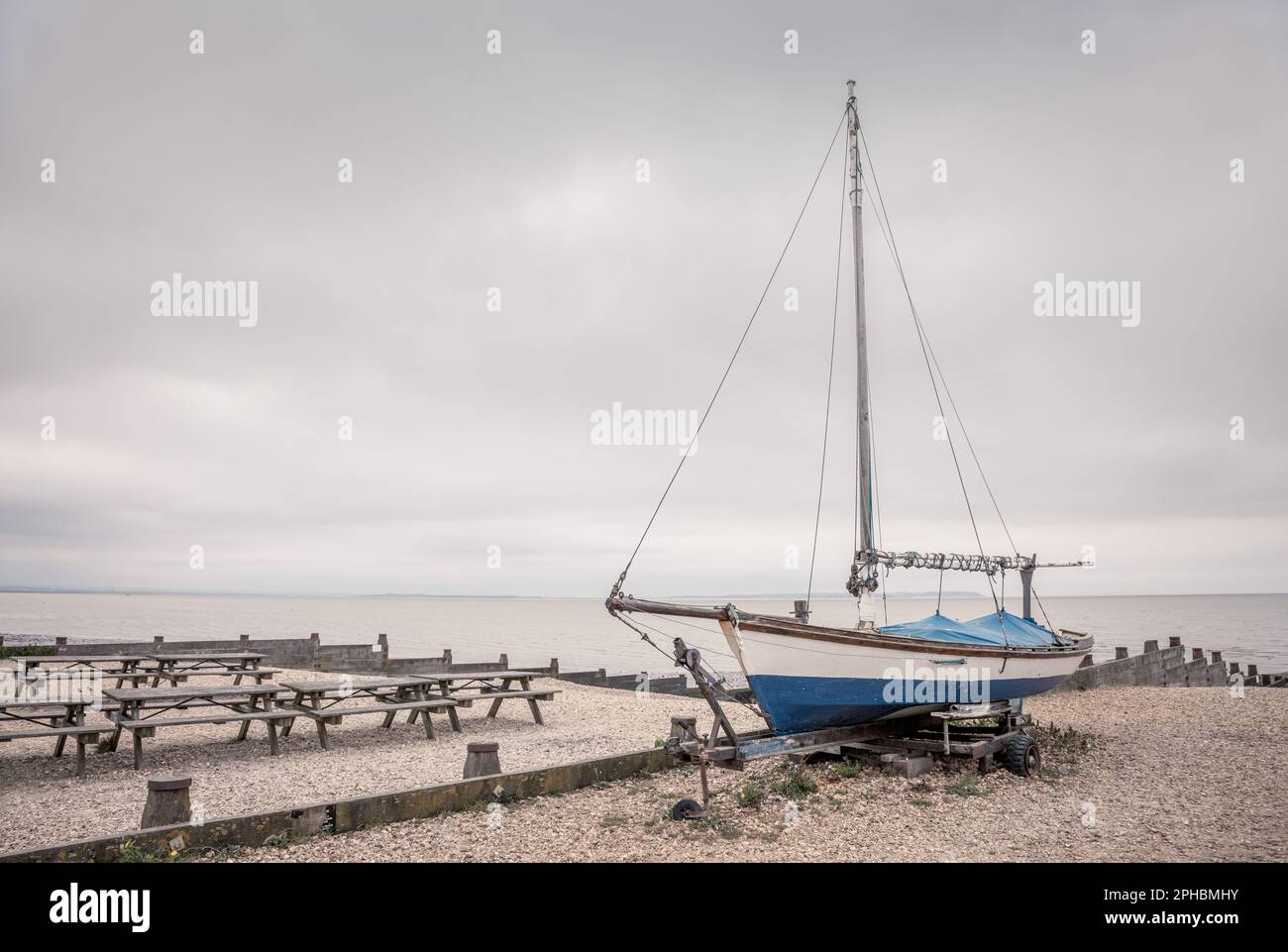 Ein Segelboot am Kieselstrand in Whitstable an der Kent Coast, Großbritannien. Stockfoto