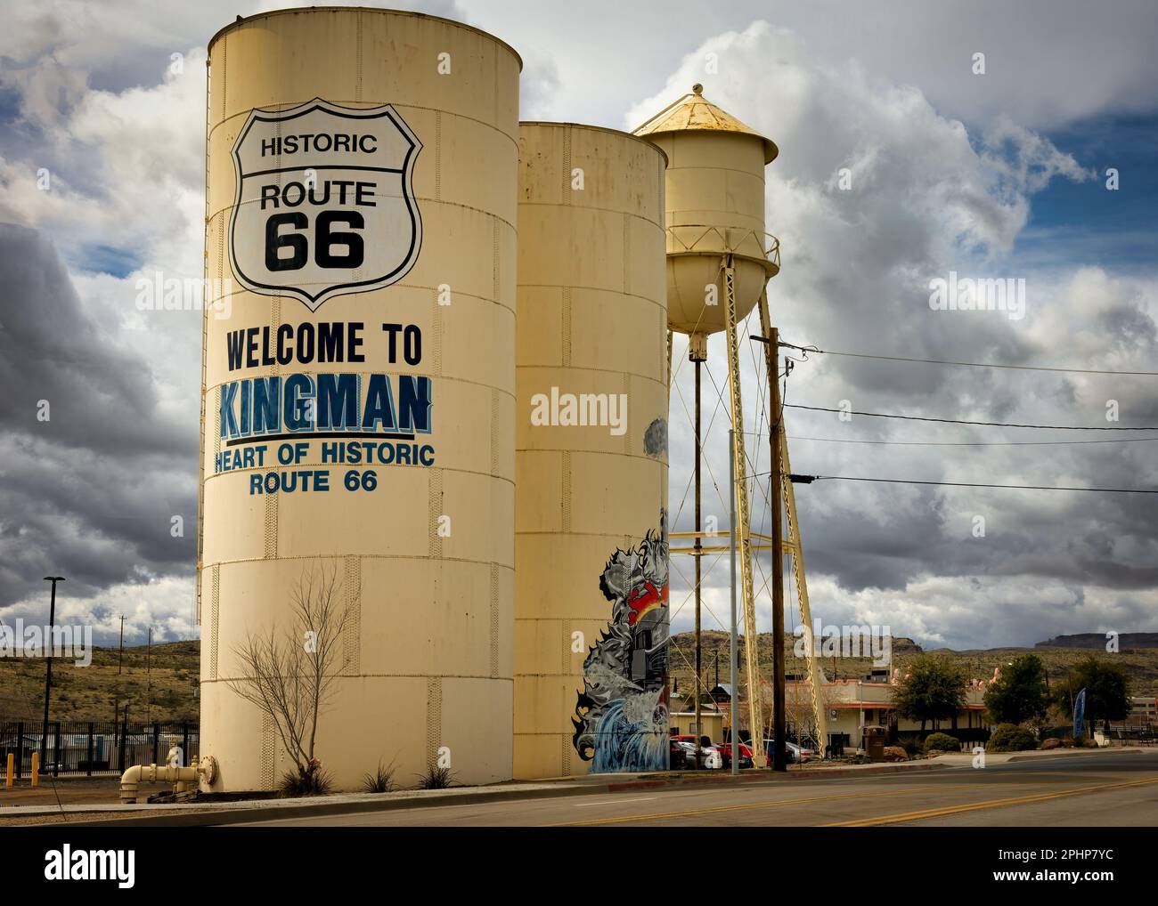 Hinter einem Wassertank, der Besucher auf der historischen Route 66 nach Kingman, Arizona, willkommen heißt, gibt es Sturmwolken. Stockfoto