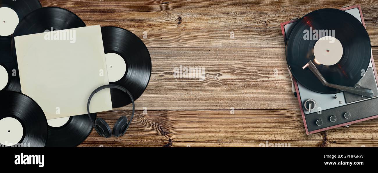 Schallplatten und Plattenspieler auf altem Holzhintergrund. Datensammlung. Musik im Vintage-Stil. Klassisches Stereo-Set. Audioanlage. Analog Soun Stockfoto