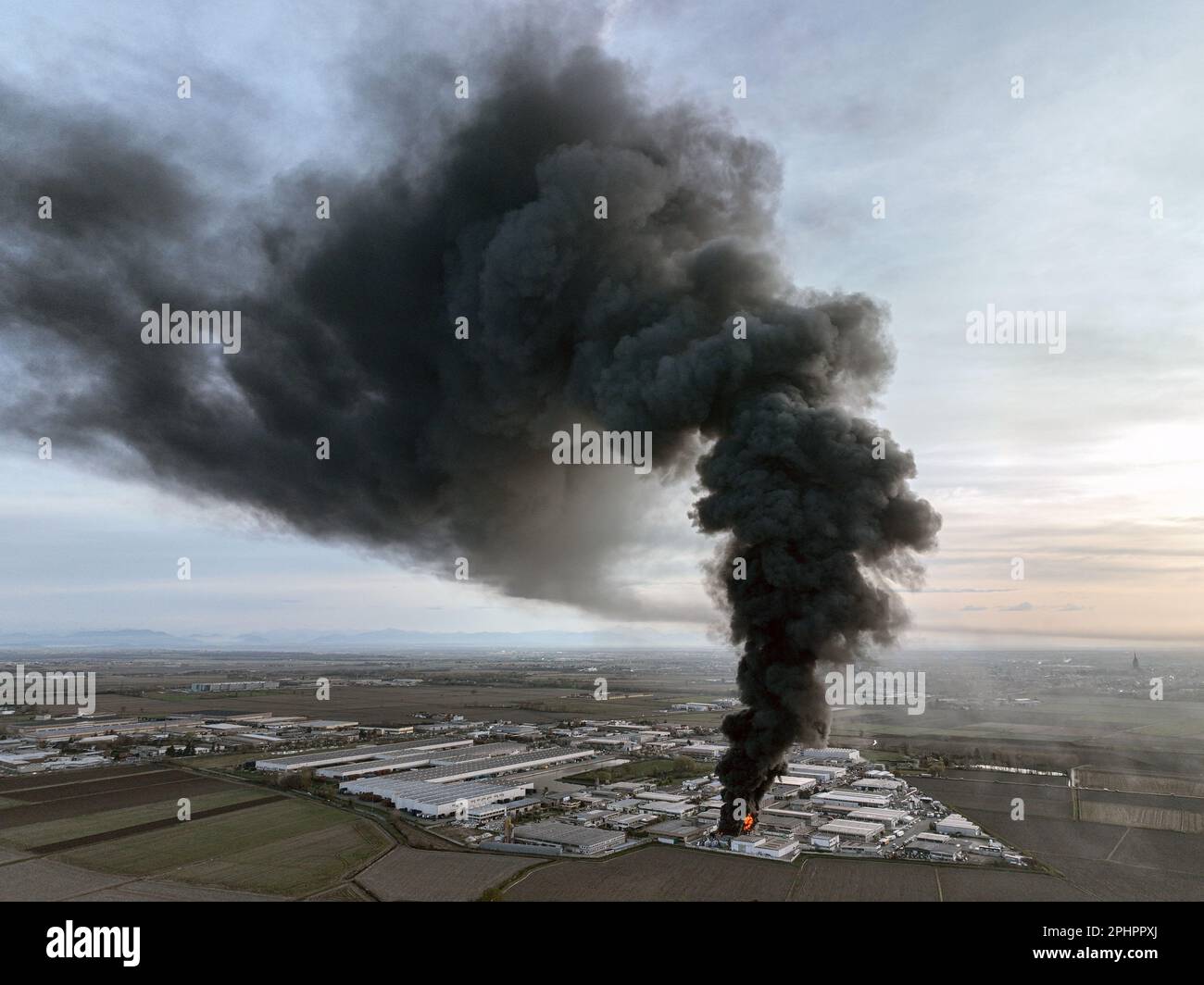 Die chemische Lösungsmittelanlage brennt mit einer schwarzen Säule giftigen Rauchs nieder. Novara, Italien - März 2023 Stockfoto