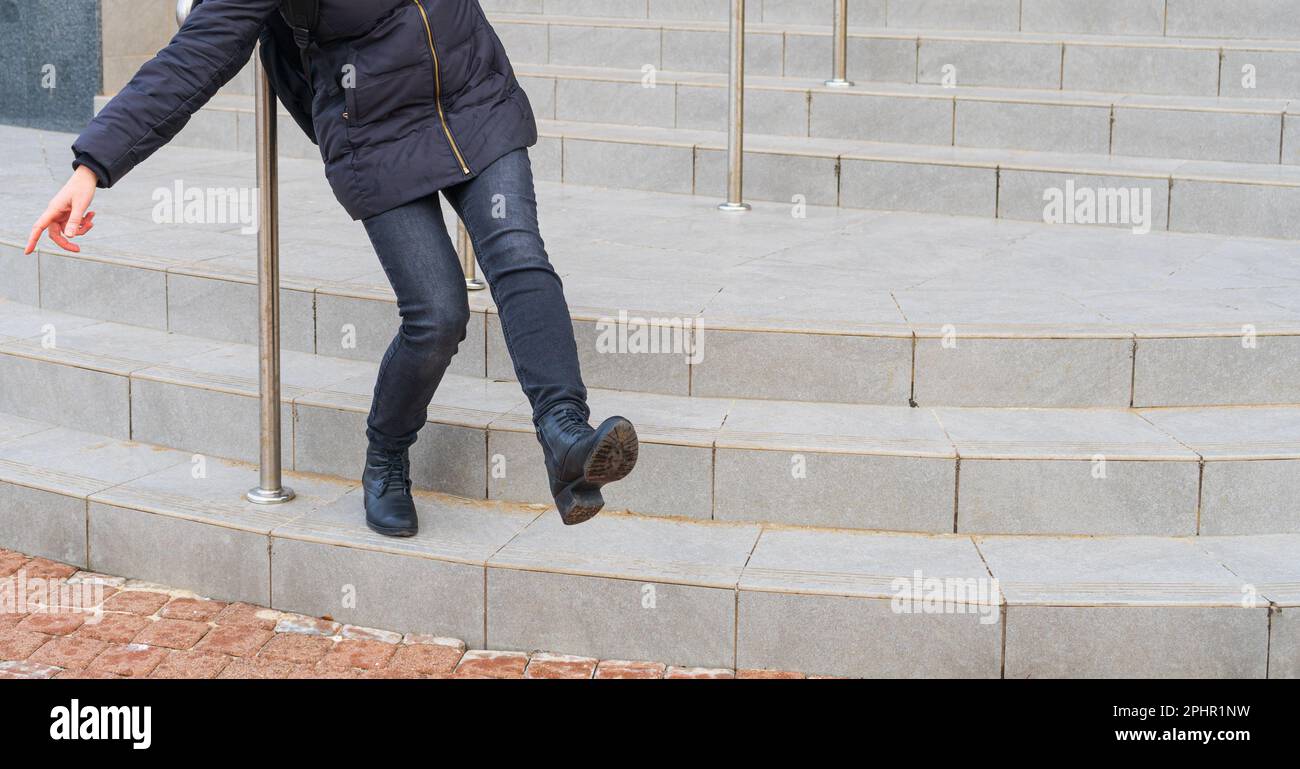 Fallende Frau auf rutschigen Treppen, Eistreppen gefallen, unsichere nasse Treppen, Problem mit rutschigen Treppen, Versicherungskonzept Stockfoto