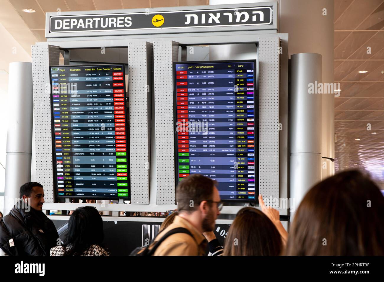 Tel Aviv, Israel. 27. März 2023. Fluggäste sehen sich die Anzeigetafel für Flüge an, die auf verspätete Flüge vom Flughafen Tel Aviv Ben Gurion aufgrund eines Streiks der Gewerkschaft nach der Entlassung des Verteidigungsministers Yoav Gallant durch Premierminister Benjamin Netanjahu hinweisen. (Credit Image: © Matan Golan/SOPA Images via ZUMA Press Wire) NUR ZUR REDAKTIONELLEN VERWENDUNG! Nicht für den kommerziellen GEBRAUCH! Stockfoto