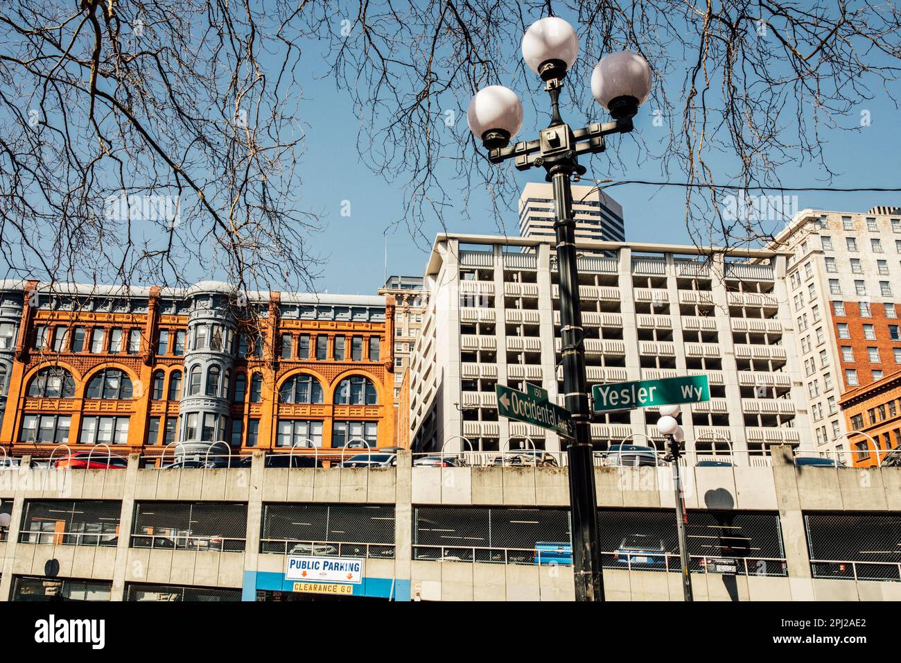 Blick auf die Gebäude nördlich der Occidental Ave S und des Yesler Way Schilds in Seattles Pioneer Square Viertel Stockfoto