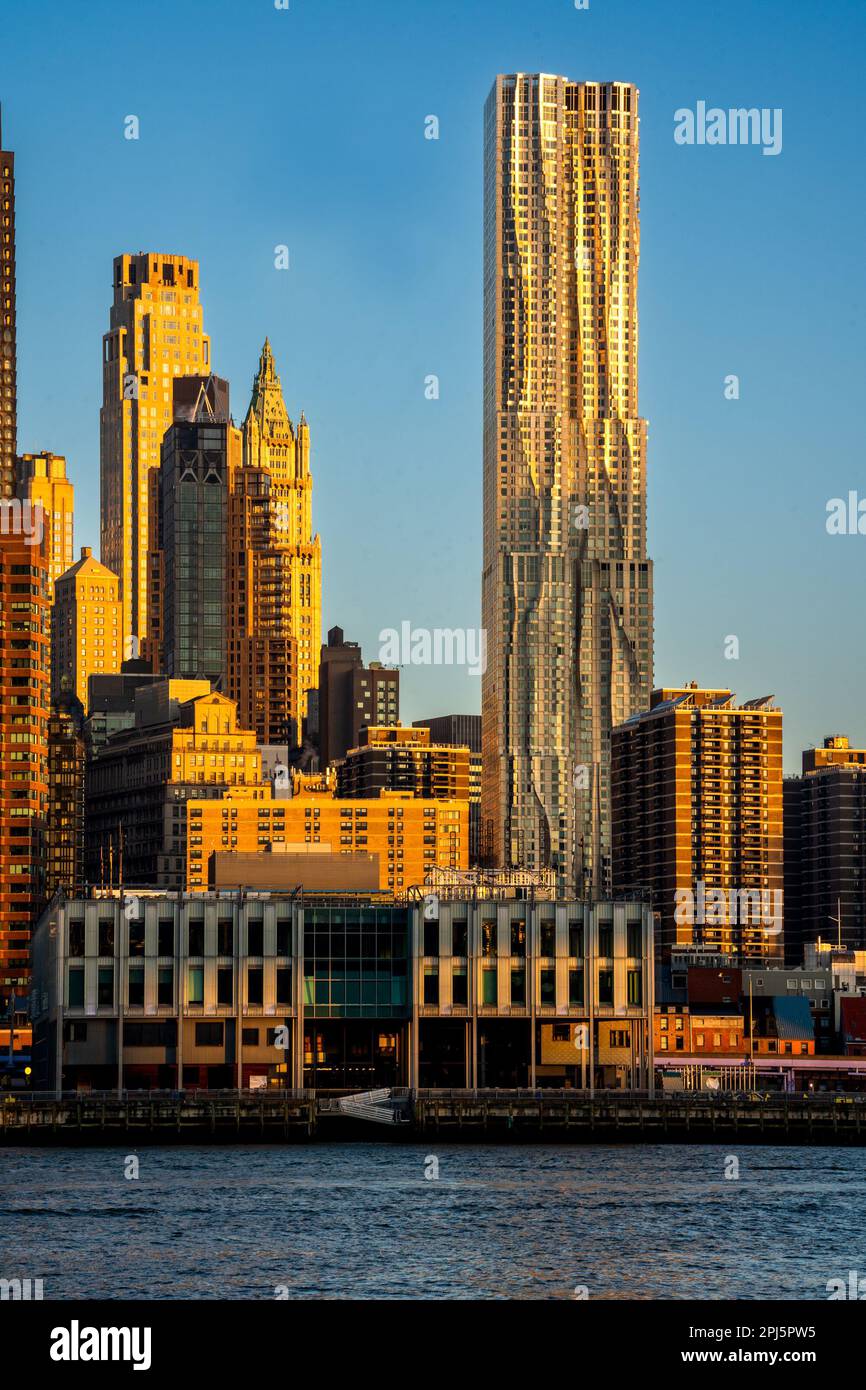 Brooklyn, NY - USA - 26. März 2023 Vertikaler Sonnenaufgang mit Blick auf die Skyline von Lower Manhattan und Frank Gehrys 8 Spruce Street, eine postmoderne 76-stöckige Straße Stockfoto