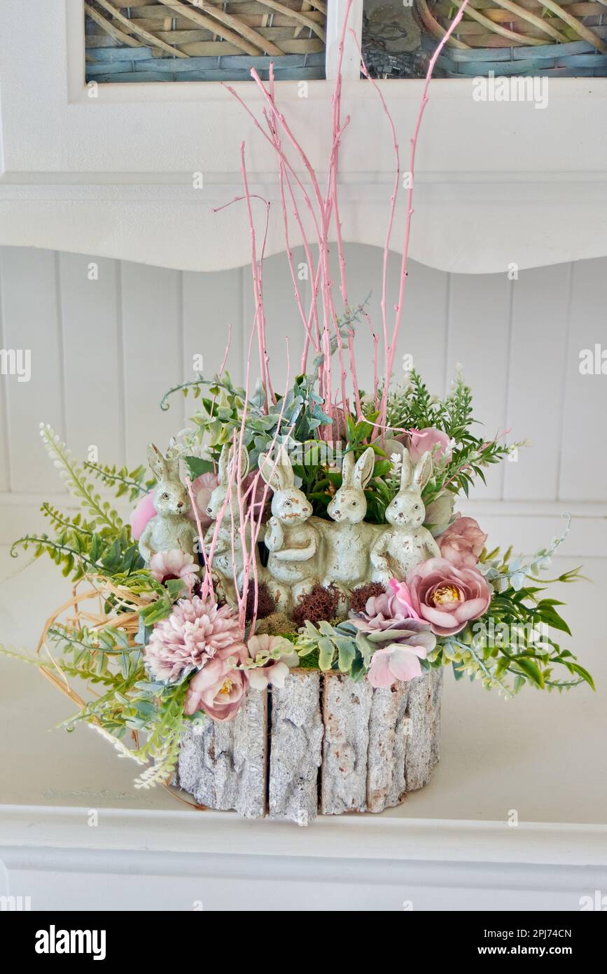Künstliche Blumenarrangements auf weißen Möbeln Stockfoto