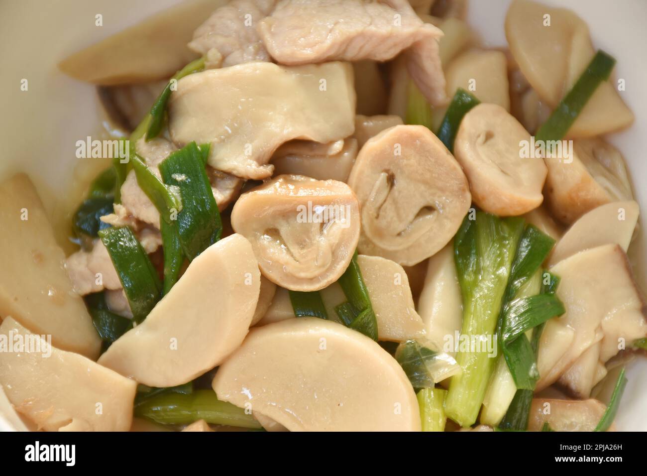 Gebratene Pilze mit Schweinefleisch in Austernsauce auf der Schüssel umrühren Stockfoto