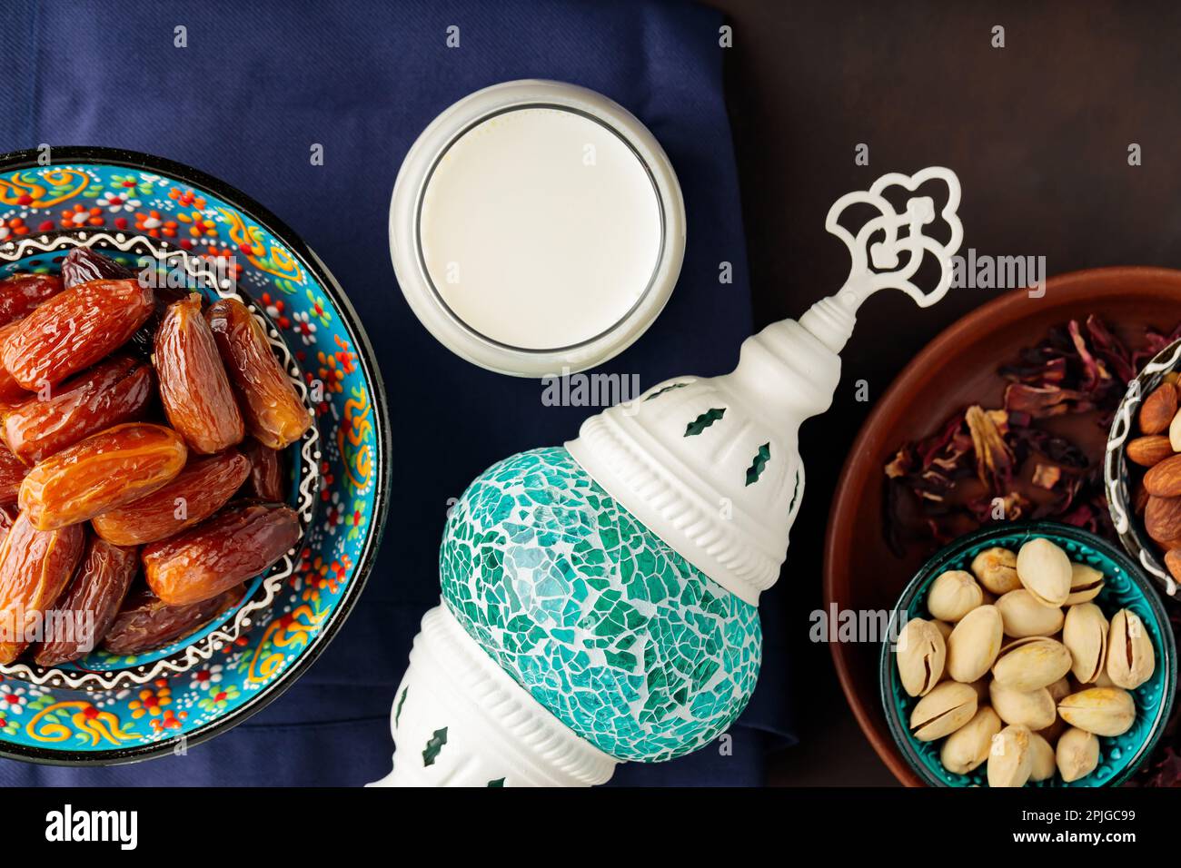 Ramadan Kareem – Speisen und Getränke. Datteln Sie Früchte, Nüsse und Milch auf dunklem Hintergrund. Das Ramadan-Karäm-Fasting-Monatskonzept. Draufsicht Stockfoto