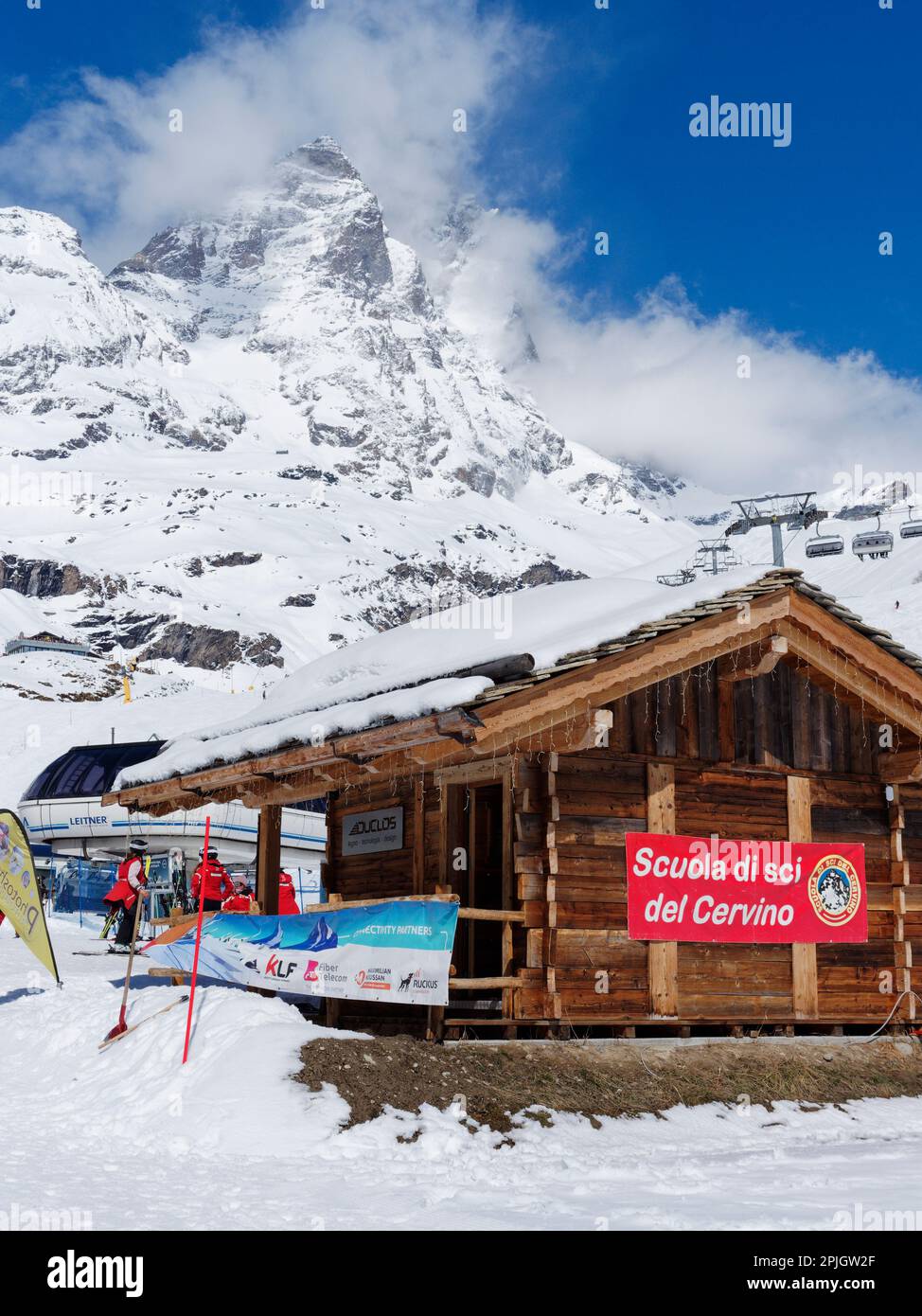 Skischule im Ferienort Breuil-Cervinia im Aosta-Tal, Italien, mit einem Sessellift und dem schneebedeckten Cervino-Berg, auch bekannt als Matterhorn, dahinter. Stockfoto