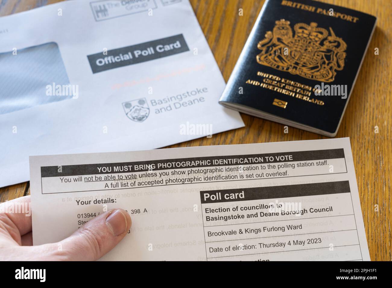 Neue Wählerausweisgesetze verlangen erstmals bei den Kommunalwahlen im Mai 2023 eine fotografische Identifizierung. Ein Mann mit einer offiziellen Wahlkarte. UK Stockfoto
