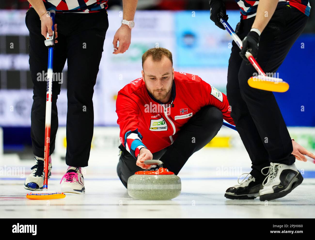 Norwegian skip Magnus Ramsfjell throws while taking on Canada at the