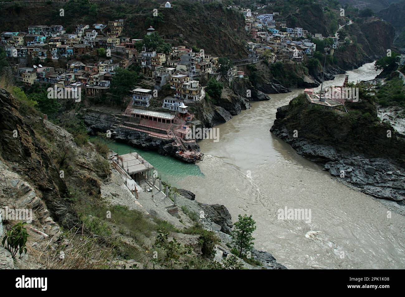 Blick auf den Zusammenfluss von zwei Flüssen Mandakini (grünes Wasser) und Alakananda (Schlammwasser) in Deva Prayag, die weiter als Fluss Ganga in Uttarakhan hinunterfließen Stockfoto
