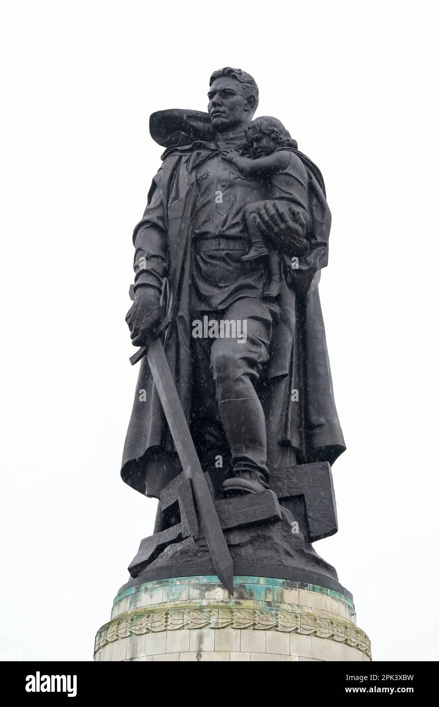 DEUTSCHLAND, ehemaliges Ostberlin, Treptow, sowjetisches Denkmal für den Zweiten Weltkrieg und Soldatenfriedhof mit 7000 Gräbern im Treptower Park, 1946-49 erbaut, Skulptur eines Soldaten mit Kind und Schwert, der die Nazi-Hakenkreuze vernichtet / DEUTSCHLAND, Berlin, Treptower Park, sowjetische Friedenmal und Soldatenfriedhof der Roten Armee im Zweiten Weltkrieg, Skulptur Soldat mit Kind auf dem Arm und mit Schwert zerschlagenes Hakenkreuz Stockfoto