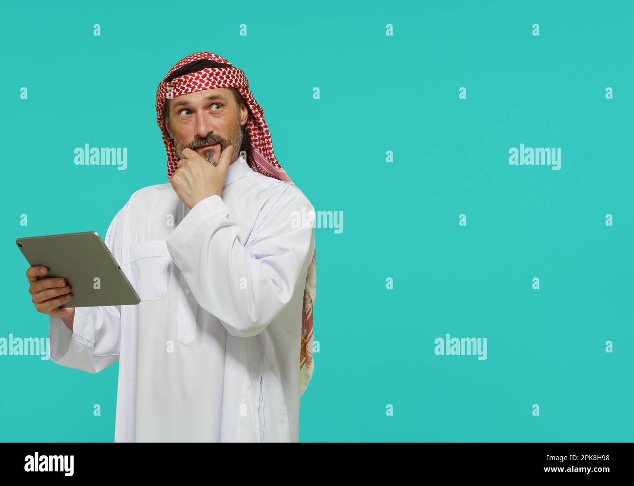Online-Shopping im Nahen Osten. Ein arabischer Mann hält ein Tablet und wählt Waren und Dienstleistungen aus. Hochwertiges Foto Stockfoto