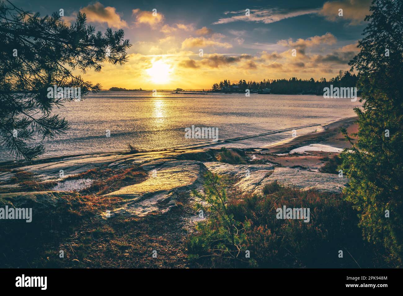 Schweden, Blick vom Ufer auf den See, ruhiges Wasser, Sonnenaufgang mit Reflexion im Wasser Stockfoto