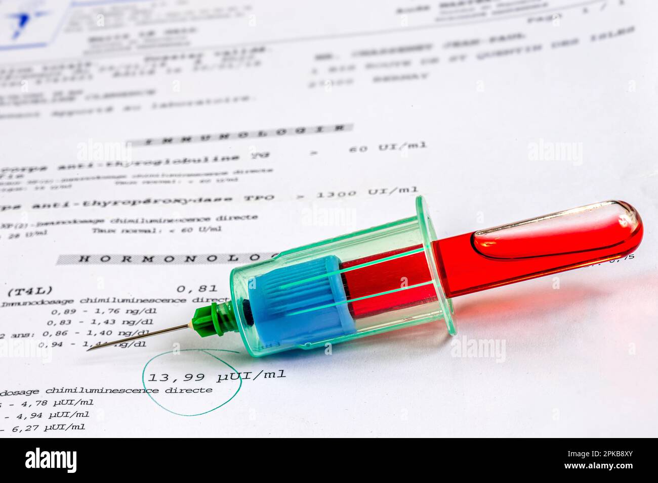 Probenkörper mit gefülltem Blutröhrchen, auf den Analyseergebnissen platziert. Stockfoto
