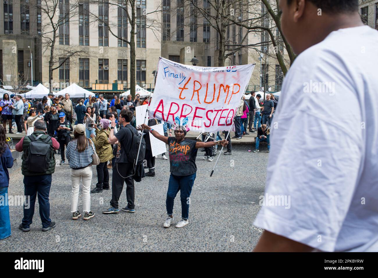 Der Anti-Trump-Unterstützer hält während der Trump-Anklageerhebung am 04. April 2023 vor dem Manhattan Criminal Court House, New York City, ein Schild mit der Aufschrift „Trump Detected“. Stockfoto
