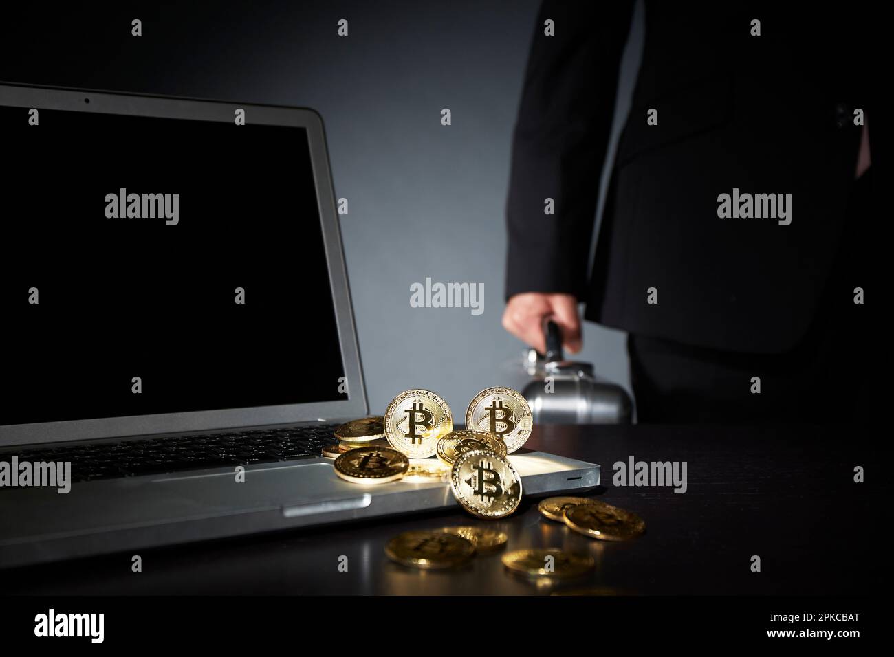 Geschäftsmann mit Bitcoin, Computer und Aktenkoffer Stockfoto