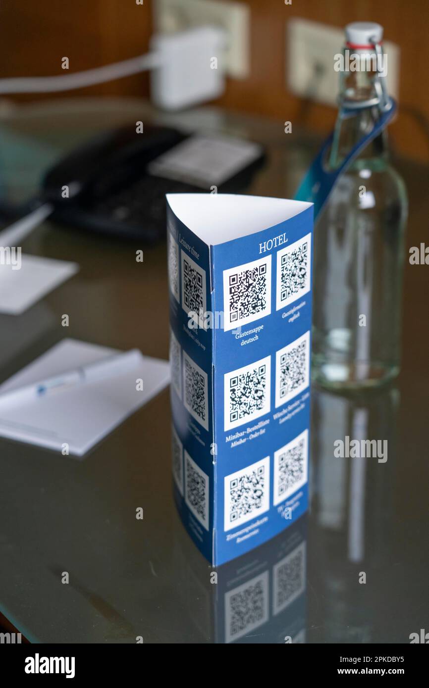 Digitalisierung im Hotel, alle üblichen Informationen auf Papier im Hotelzimmer, wie Gästemappe, Minibar-Liste, Wäscheservice-Informationen, Zimmer Stockfoto