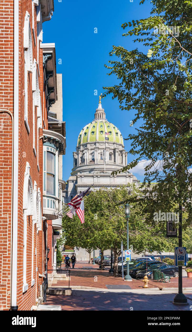 Eine von Bäumen gesäumte Straße mit bezaubernden Backsteingebäuden, die auf das Pennsylvania State Capitol Building in Harrisburg, Pennsylvania, USA, gerichtet ist Stockfoto
