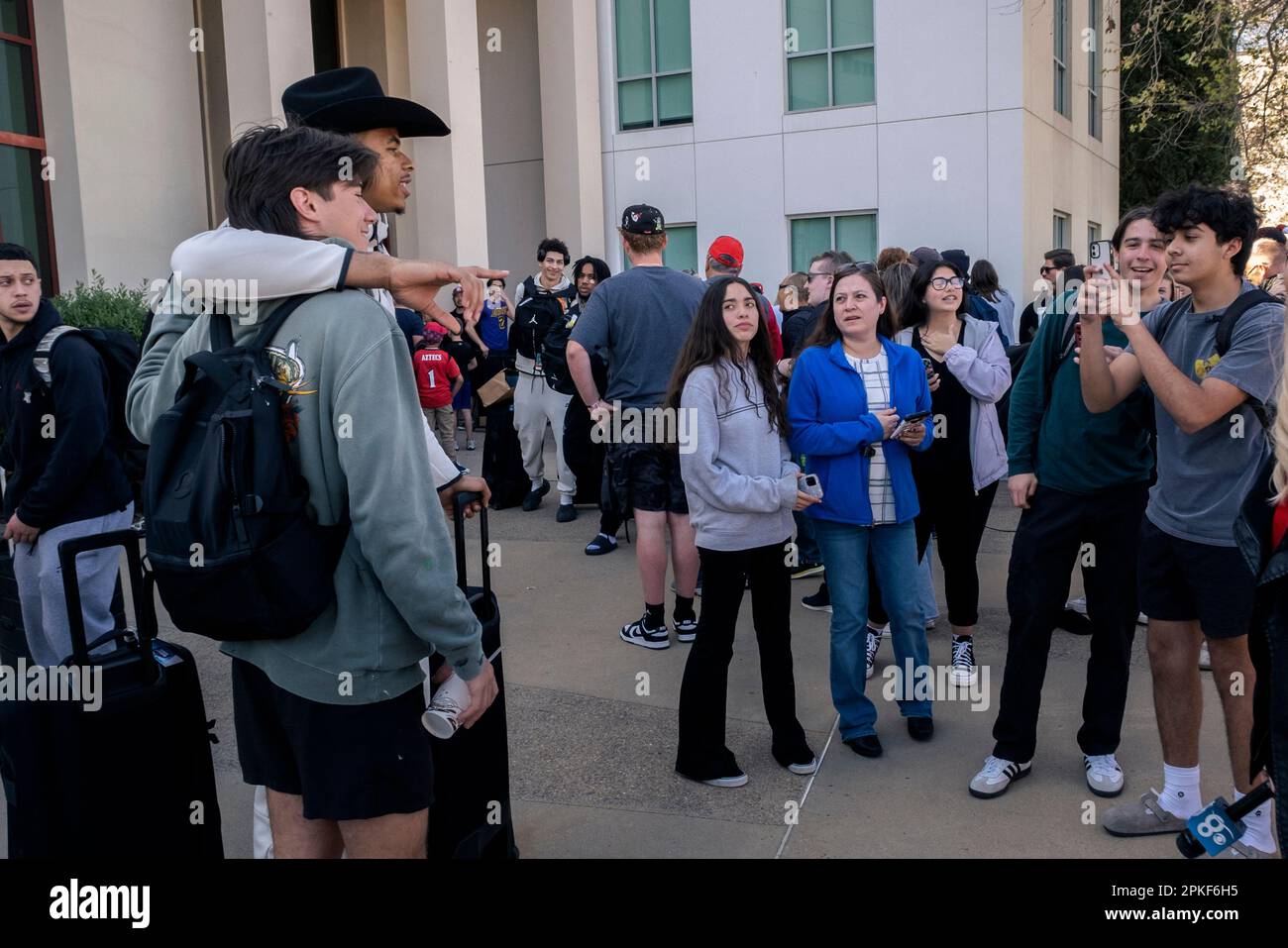 4. April 2023, San Diego, Kalifornien: Fans der San Diego State University Basketball begrüßten das Team nach dem NCAA-Turnier wieder auf dem Campus. Matt Bradley, mit dem schwarzen Cowboyhut, posierte für ein Foto mit einem Fan, nachdem er aus dem Team-Bus auf dem Campus der SDSU stieg. (MATTHEW BOWLER/KPBS/SIPA USA) **KEIN VERKAUF IN SAN DIEGO-SAN DIEGO OUT** Stockfoto